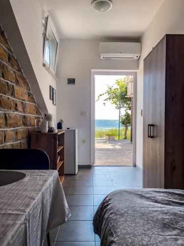 a bedroom with a view of the ocean at 4 Roses Residence in Sečovlje