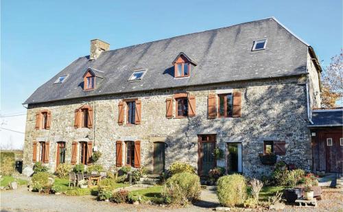 a large stone house with a gray roof at La Pagerie in Maupertuis