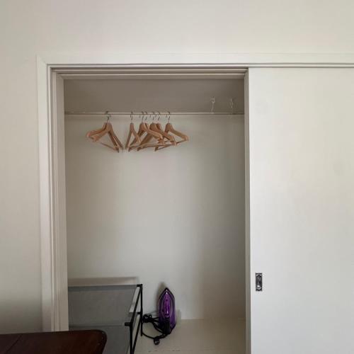 a walk in closet with hangers and a door at Casa de férias in Monte