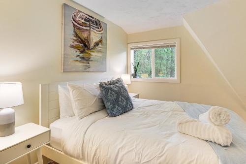 a bedroom with a white bed with a window at Dome Escape in Nature with Deck 3 Mi to Kent Falls in Warren