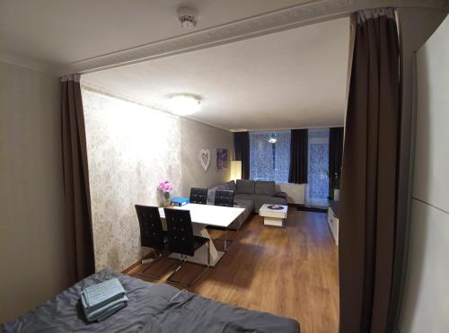 a living room with a bed and a dining room at Ferienwohnung - Glockenbergtraum - im schönen Harz, 2 Zimmer mit Südbalkon in Altenau
