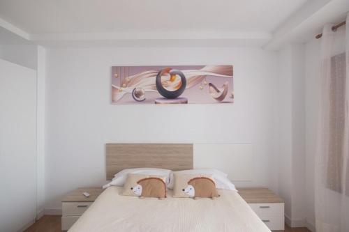 a bedroom with a bed with two stuffed animals on it at Entre Castillo y Catedral 2VUT09734 in Burgos