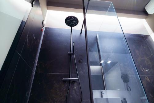 a bathroom with a shower with a glass wall at Virginia Madre Luxury Rooms in San Benedetto del Tronto