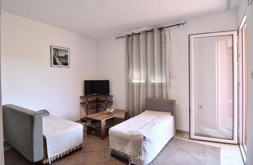 a living room with a chair and a window at Perfect Location close to Jaz beach - Apartments Rora Knezevic in Budva