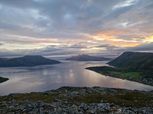 a view of a large body of water at sunset at Warm and cosy apartment in Tromsø