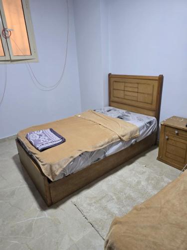 a bedroom with a bed and a night stand at Pyramids Private Gate in ‘Ezbet `Abd el-Ḥamîd