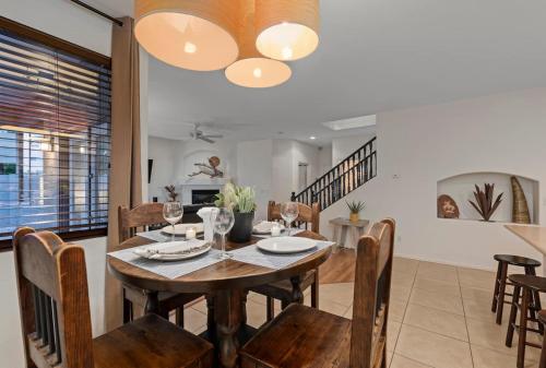 a dining room with a wooden table and chairs at Golf Course Executive Home With Free Heated Pool! in Avondale