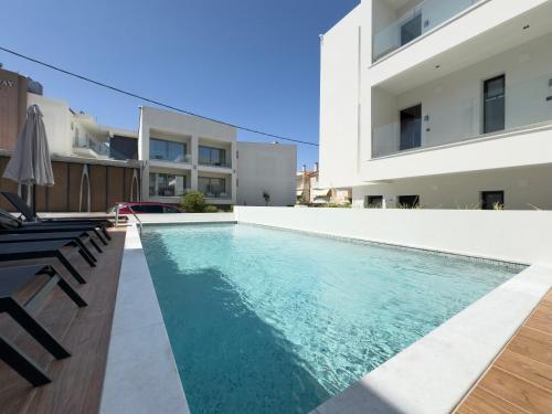 a swimming pool in the backyard of a house at Mare Luxury Studios in Kallithea Halkidikis