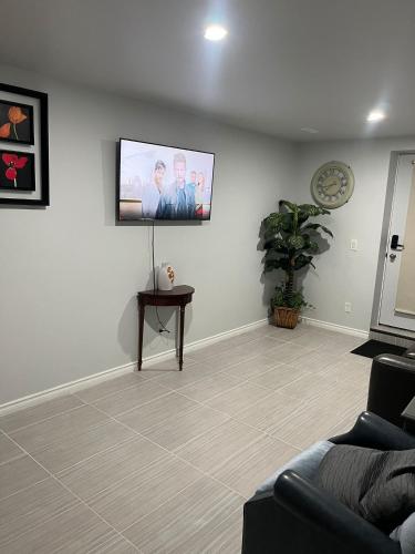 a living room with a flat screen tv on the wall at Cozy and comfy 1 BEDROOM basement suite at Cougar ridge SW Calgary in Calgary