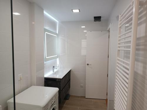 a white bathroom with a sink and a washing machine at Entre Castillo y Catedral 2VUT09734 in Burgos