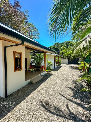 a house with a gravel driveway next to a building at Yiven Natural Village in Puerto Viejo