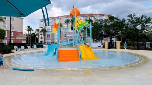 a child is playing in a water park at 2BR Condo close Convention Center l Epic in Orlando