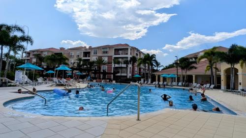 a group of people in a pool at a resort at 2BR Condo close Convention Center l Epic in Orlando