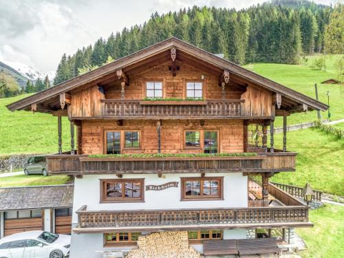 a wooden house with a balcony on top of it at Birkheim in Inneralpbach