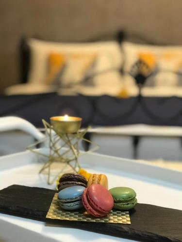 a tray with donuts and a candle on a table at 宜蘭頭城A Happy Birthday 私人溫泉 海景 蘭陽夜景大陽台無邊際泳池 in Toucheng