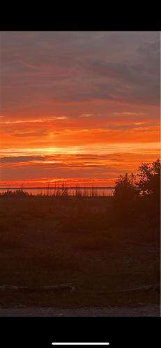 a sunset in a field with the sky at Tobermory Tides bed and breakfast in Tobermory