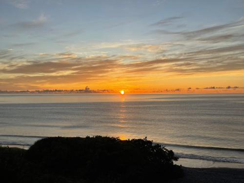 a sunset over the ocean with the sun setting at Taitung Blue Sea Villa in Chenggong