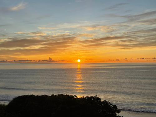 a sunset over the water with the sun setting at Taitung Blue Sea Villa in Chenggong