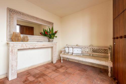 a living room with a bench and a fireplace at Casa D Boutique in Cartagena de Indias