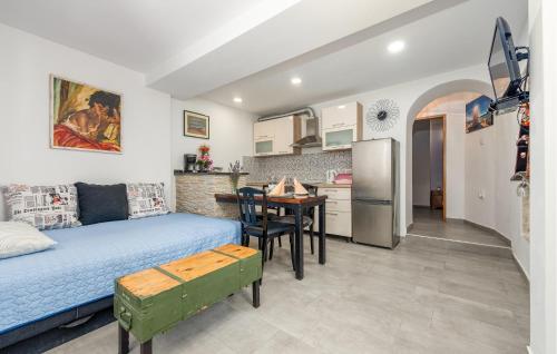 a room with a bed and a table and a kitchen at 1 Bedroom Lovely Apartment In Ljubac in Ljubač