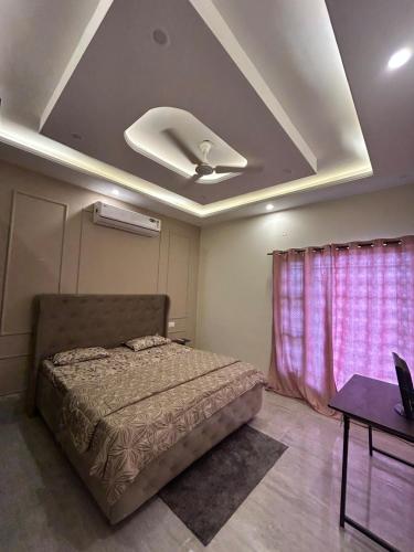a bedroom with a bed and a ceiling at Beauty Living in Kharar