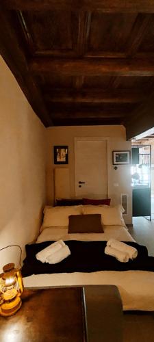 a bedroom with a large bed with two pillows at Eifù - Un antico nido ritrovato in Robecco sul Naviglio