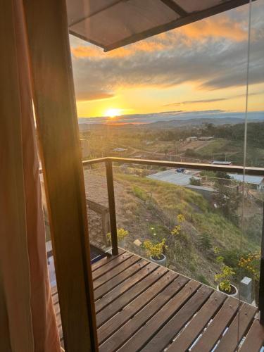 a view of a sunset from the balcony of a house at Pousada Recanto Querubins in Paty do Alferes