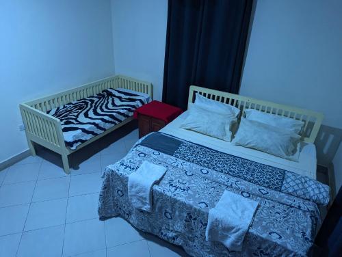 Кровать или кровати в номере JACARANDA HOMESTAY