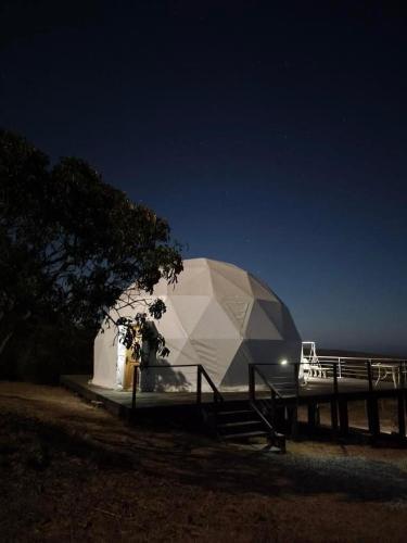 a large white tent at night in a field at Espectacular Domo Rústico con Vista en Los Vilos, equipado hasta 5 personas in Los Vilos