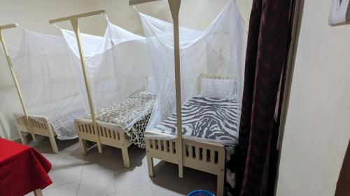 Кровать или кровати в номере JACARANDA HOMESTAY