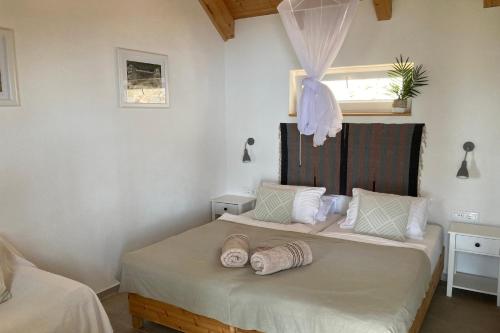 a bedroom with a bed with two pillows on it at Holiday house with a swimming pool Gromin Dolac, Hvar - 24689 in Jelsa