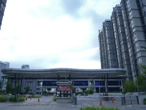a bus stop in a city with tall buildings at Cozy Studio unit,Cyberjaya,Wifi, Netflix,Free parking in Cyberjaya