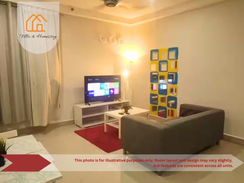 a living room with a couch and a tv at Cozy Studio unit,Cyberjaya,Wifi, Netflix,Free parking in Cyberjaya