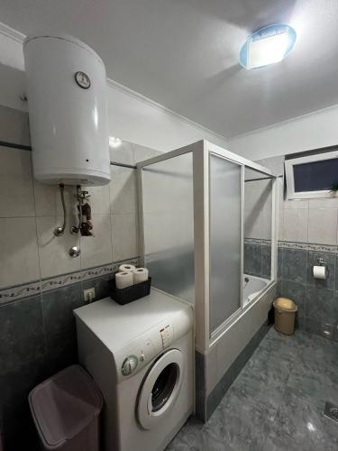 a small bathroom with a washing machine in it at Apartman Nada in Biograd na Moru