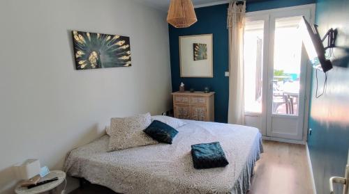 a bedroom with a bed with two pillows on it at Maison avec patio in Arles