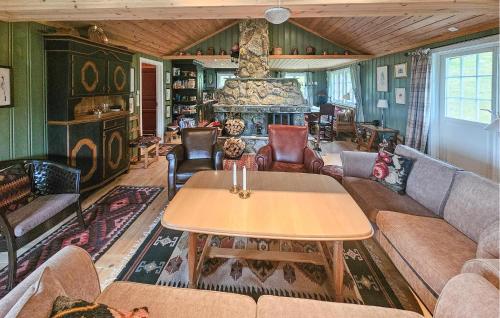 a living room with a couch and a table at Amazing Home In Eggedal With Sauna in Eggedal