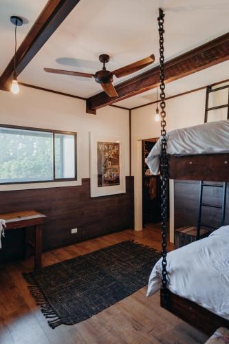 a bedroom with a bed and a ceiling fan at VintageSteel Hinton in Hinton