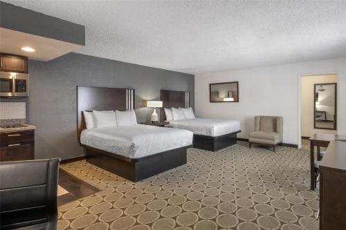 a hotel room with two beds and a kitchen at Best Western Pahrump Oasis in Pahrump