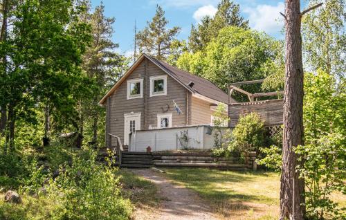 a house in the woods with a driveway at 3 Bedroom Beautiful Home In Nynäshamn in Nynäshamn