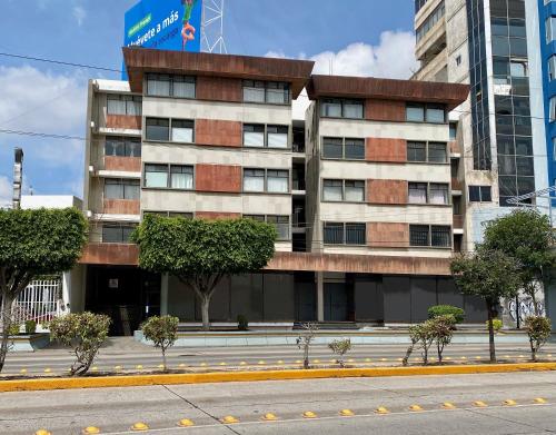 a tall building with trees in front of a street at BaW Mateos 809P in León