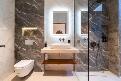 a bathroom with a sink and a toilet at Jago Gili Air in Gili Islands