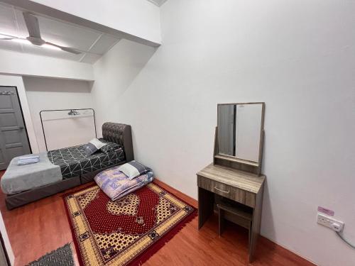 a room with a bed and a mirror and a table at Homestay Semporna in Semporna