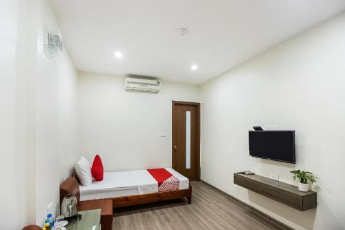a bedroom with a bed and a tv on a wall at Nha Khach Giao Thong in Hanoi