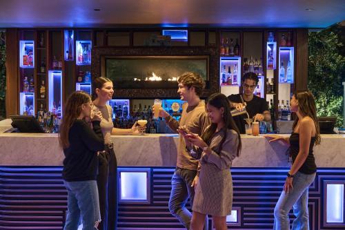 a group of people standing in front of a bar at Rydges South Bank Brisbane in Brisbane