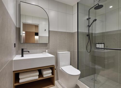a bathroom with a toilet and a sink and a shower at Hyatt House South Melbourne in Melbourne