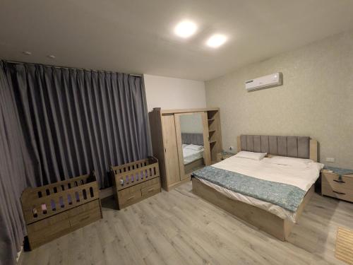 a bedroom with a bed and a mirror in it at Aeropuerta Mini Villa - Private self check-in Layover near Amman Airport in Al Qasţal