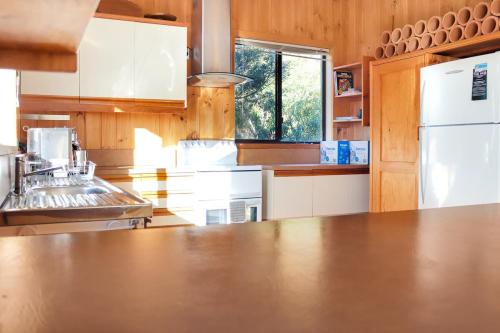 a kitchen with a stainless steel counter top at High On Coffey - Binalong Bay - Pet Friendly in Binalong Bay