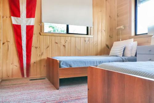 a bedroom with two beds and a flag on the wall at High On Coffey - Binalong Bay - Pet Friendly in Binalong Bay