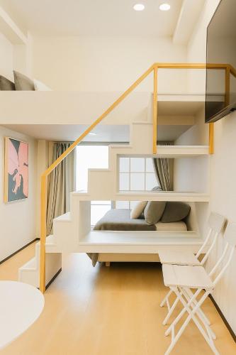 una habitación con una escalera de caracol en una casa en 誠家 Makoto Hotel, en Tokio