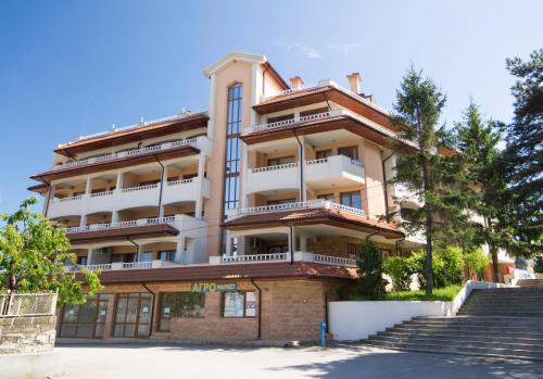 an apartment building with stairs in front of it at Byala Home Apartment Complex in Byala